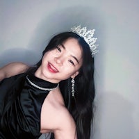 a woman in a black dress with a tiara